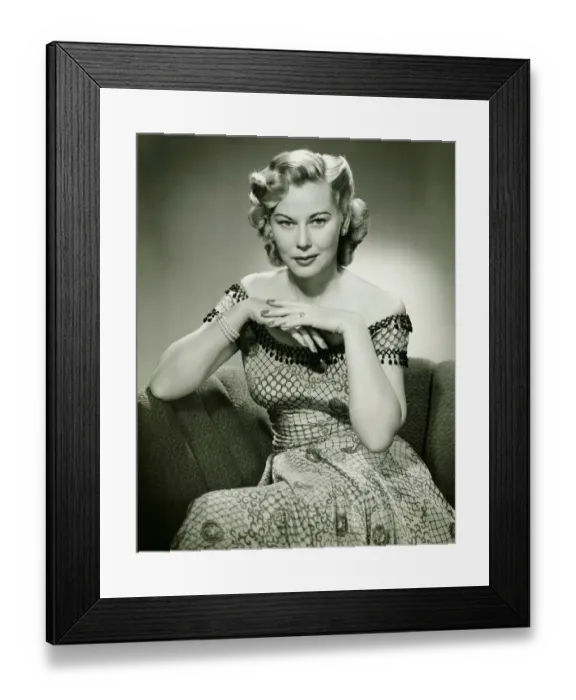 Framed Print : Young woman sitting on sofa, (B&W), portrait