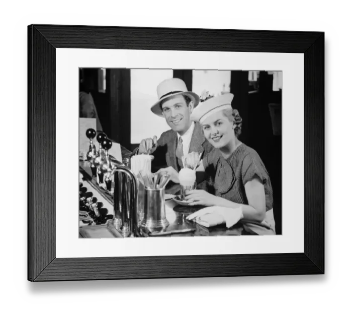 Framed Print : Man and woman in fancy hat drinking ice cream soda (B&W), portrait Framed Print : Man and woman in fancy hat drinking ice cream soda (B&W), portrait