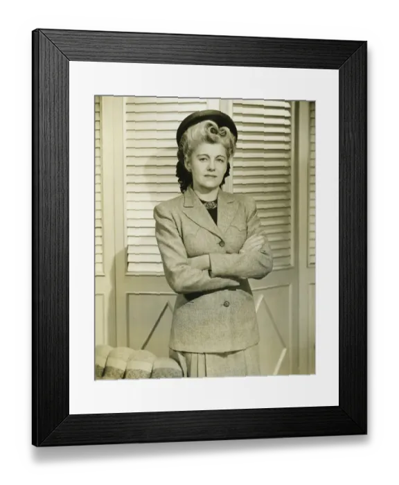 Framed Print : Woman in fashionable suit standing indoors, (B&W) Framed Print : Woman in fashionable suit standing indoors, (B&W)