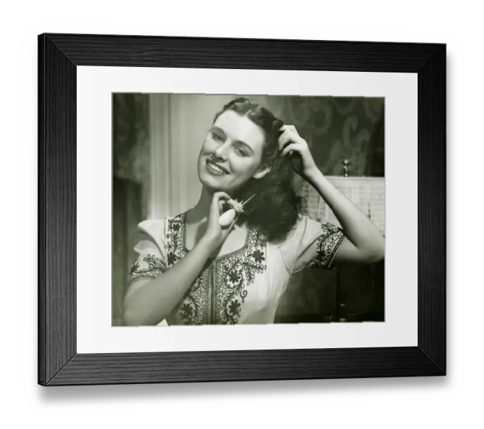 Framed Print : Young woman combing hair, (B&W), portrait Framed Print : Young woman combing hair, (B&W), portrait