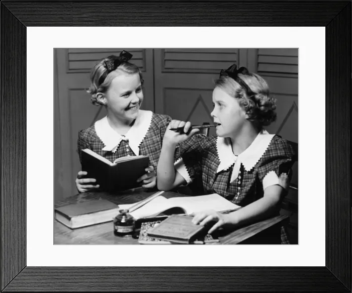 Framed Print : Two girls (10-11) doing homework (B&W) Framed Print : Two girls (10-11) doing homework (B&W)