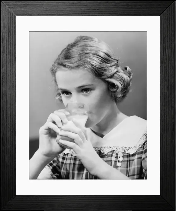 Framed Print : Girl (8-9) drinking milk from glass (B&W) Framed Print : Girl (8-9) drinking milk from glass (B&W)