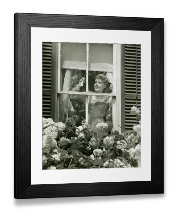 Framed Print : Woman adjusting widow blind, (B&W) Framed Print : Woman adjusting widow blind, (B&W)