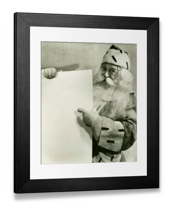 Framed Print : Santa Claus holding blank sheet of paper, (B&W), portrait Framed Print : Santa Claus holding blank sheet of paper, (B&W), portrait