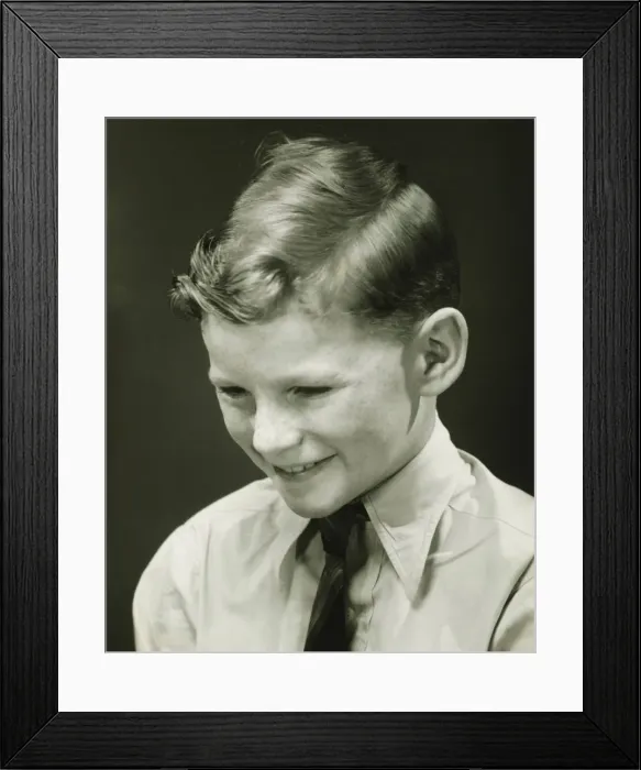 Framed Print : Smiling boy (10-11) posing in studio, (B&W), portrait Framed Print : Smiling boy (10-11) posing in studio, (B&W), portrait