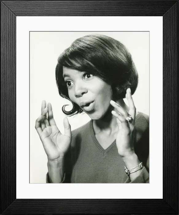 Framed Print : Young woman gesturing in studio, smiling, (B&W), close-up Framed Print : Young woman gesturing in studio, smiling, (B&W), close-up