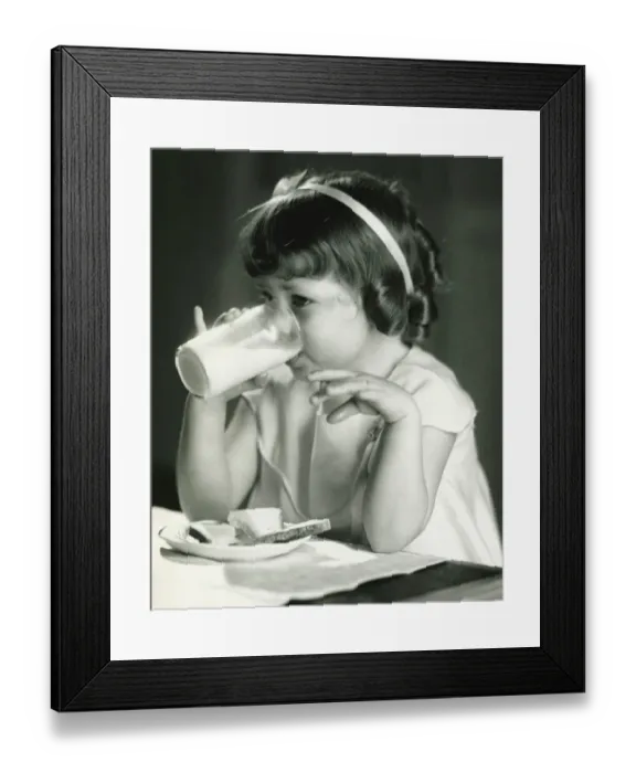Framed Print : Girl (4-5) having breakfast, (B&W) Framed Print : Girl (4-5) having breakfast, (B&W)