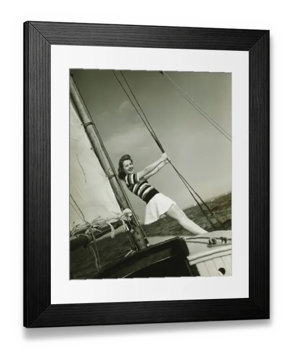 Framed Print : Young woman holding rigging on yacht, (B&W) Framed Print : Young woman holding rigging on yacht, (B&W)