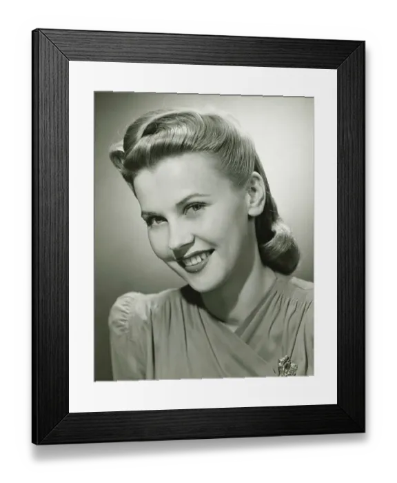 Framed Print : Young woman smiling in studio, (B&W), portrait Framed Print : Young woman smiling in studio, (B&W), portrait