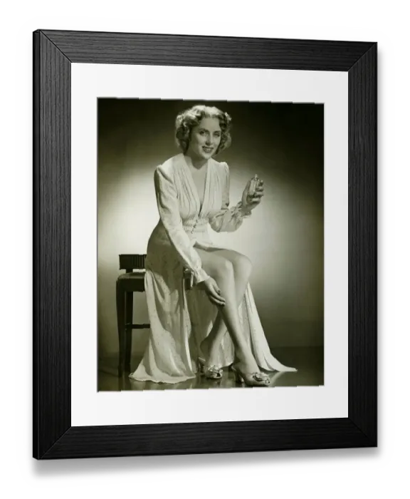 Framed Print : Woman in gown sitting on stool, holding perfume, (B&W), portrait Framed Print : Woman in gown sitting on stool, holding perfume, (B&W), portrait