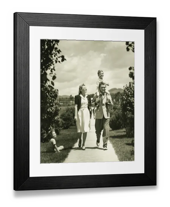 Framed Print : Family with two children (4-5) on walk, (B&W) Framed Print : Family with two children (4-5) on walk, (B&W)