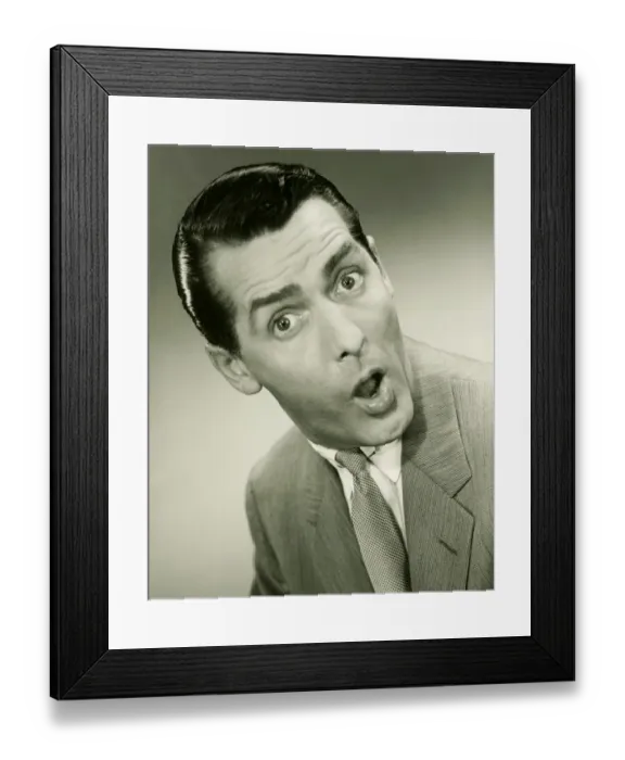 Framed Print : Businessman looking surprised, posing in studio, (B&W), portrait Framed Print : Businessman looking surprised, posing in studio, (B&W), portrait