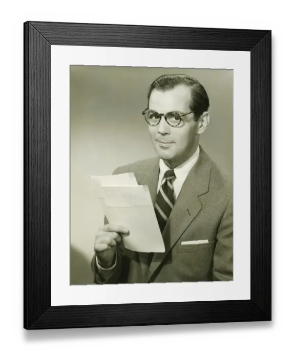 Framed Print : Businessman in studio holding papers, (B&W), portrait Framed Print : Businessman in studio holding papers, (B&W), portrait