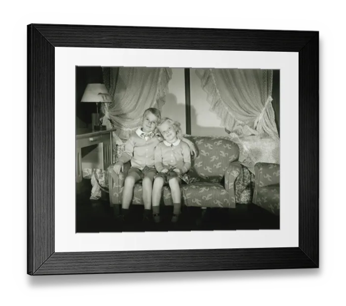 Framed Print : Brother and sister (4-5) posing in room, (B&W), portrait Framed Print : Brother and sister (4-5) posing in room, (B&W), portrait