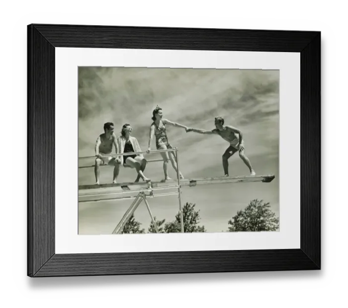 Framed Print : Two couples on springboard, (B&W), low angle view Framed Print : Two couples on springboard, (B&W), low angle view