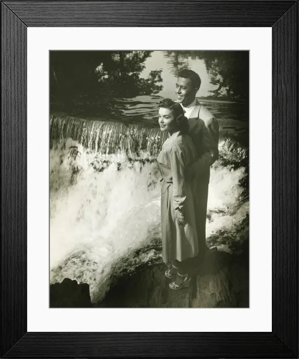 Framed Print : Young couple standing by waterfall, (B&W) Framed Print : Young couple standing by waterfall, (B&W)