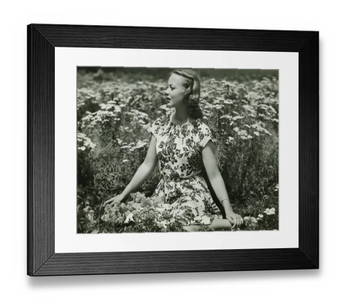 Framed Print : Woman in flowery dress sitting in meadow among flowers, (B&W), portrait Framed Print : Woman in flowery dress sitting in meadow among flowers, (B&W), portrait