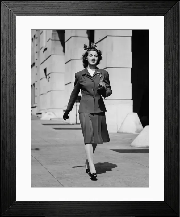 Framed Print : Young woman walking on sidewalk, (B&W) Framed Print : Young woman walking on sidewalk, (B&W)