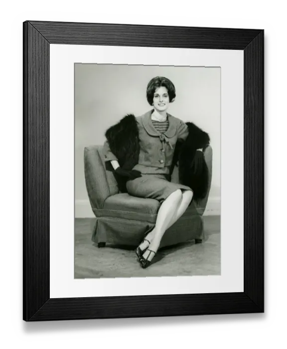 Framed Print : Elegant woman sitting on arm chair in studio, (B&W), portrait Framed Print : Elegant woman sitting on arm chair in studio, (B&W), portrait