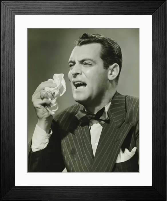 Framed Print : Man sneezing in studio, (B&W) Framed Print : Man sneezing in studio, (B&W)