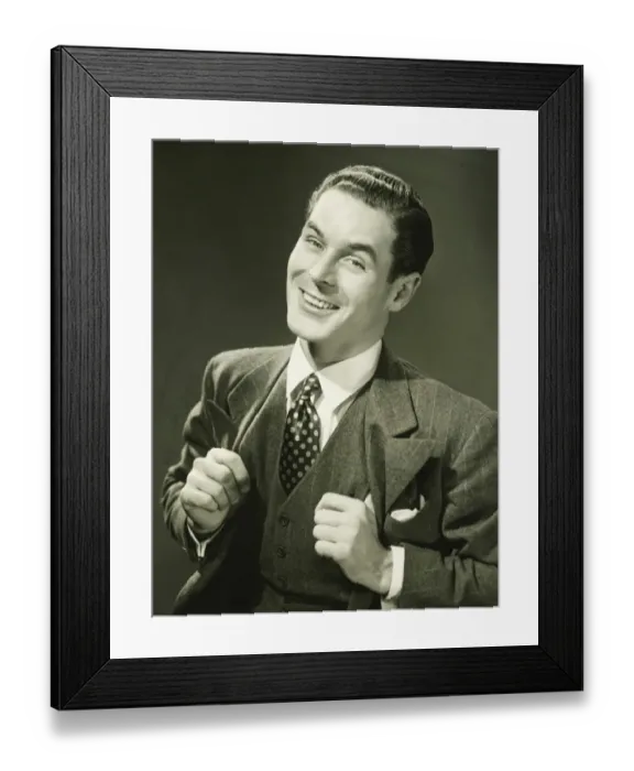 Framed Print : Young businessman in studio smiling, (B&W), portrait Framed Print : Young businessman in studio smiling, (B&W), portrait