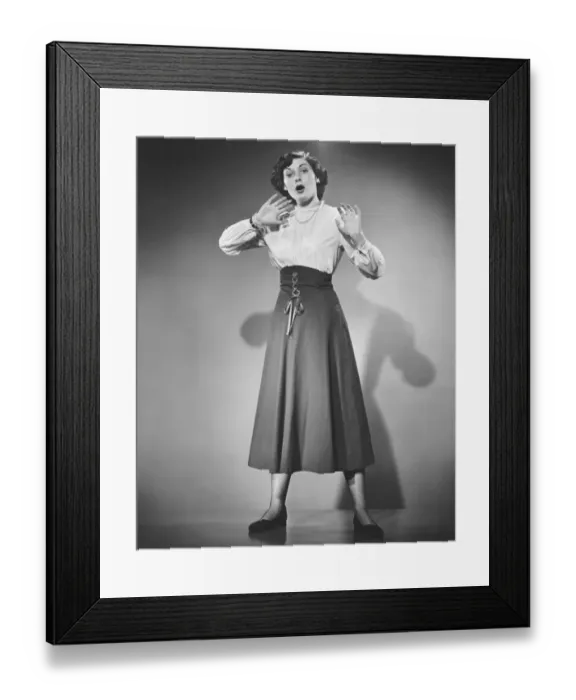 Framed Print : Woman gesturing in studio, (B&W), portrait Framed Print : Woman gesturing in studio, (B&W), portrait