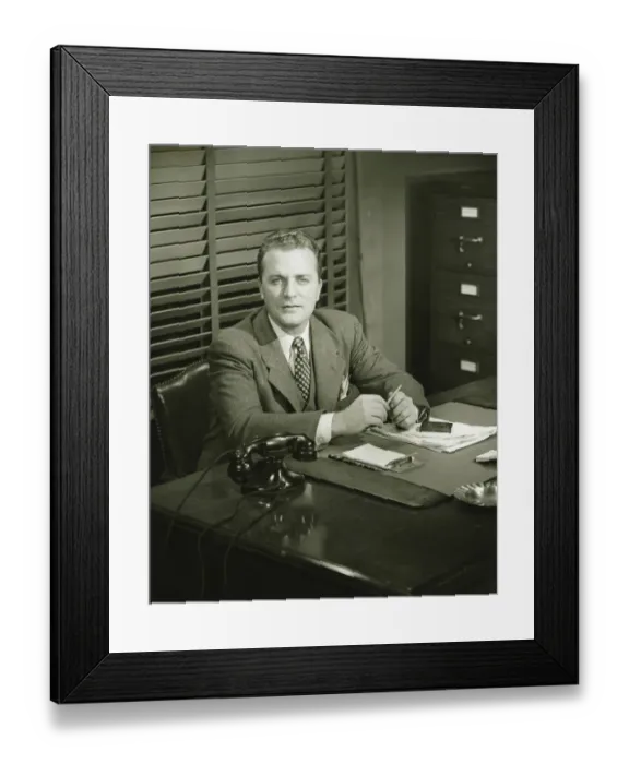 Framed Print : Businessman holding pencil, sitting at office, (B&W) Framed Print : Businessman holding pencil, sitting at office, (B&W)