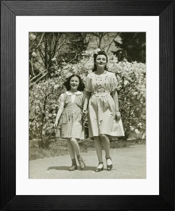 Framed Print : Mother and daughter (8-9) strolling in park, (B&W) Framed Print : Mother and daughter (8-9) strolling in park, (B&W)