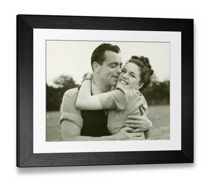 Framed Print : Young couple embracing in field, man kissing woman, (B&W)