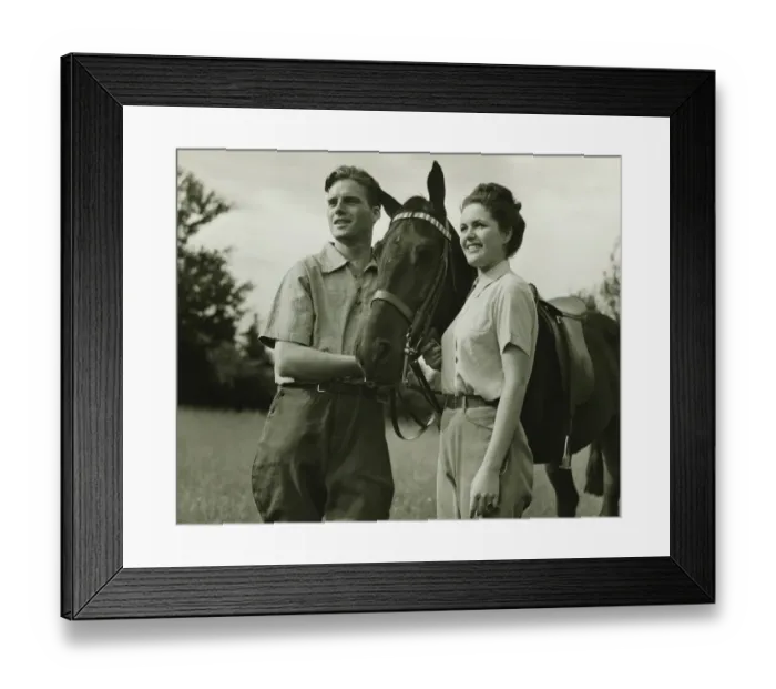 Framed Print : Young couple standing with horse in field, (B&W) Framed Print : Young couple standing with horse in field, (B&W)