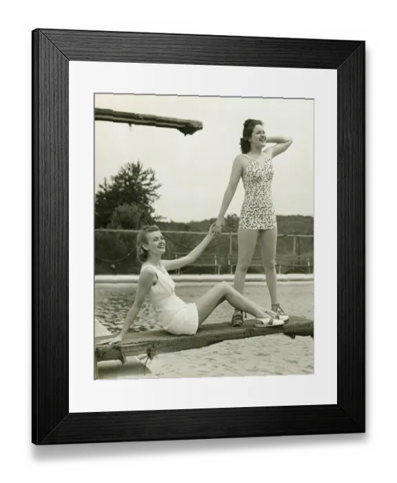Framed Print : Two young women holding hands on springboard, (B&W) Framed Print : Two young women holding hands on springboard, (B&W)