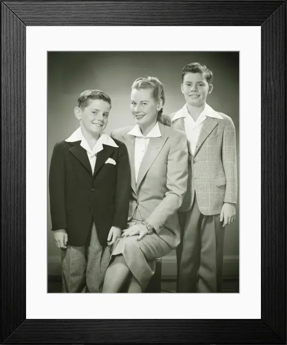 Framed Print : Mother with brothers (8-9) (10-11) sitting in studio, smiling, (B&W), portrait Framed Print : Mother with brothers (8-9) (10-11) sitting in studio, smiling, (B&W), portrait