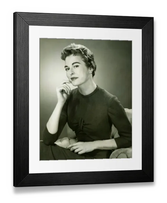 Framed Print : Smiling woman sitting in armchair in studio, (B&W), portrait Framed Print : Smiling woman sitting in armchair in studio, (B&W), portrait