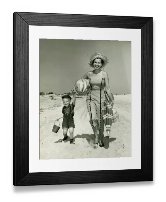 Framed Print : Mother with son (2-3) walking on beach, (B&W), portrait Framed Print : Mother with son (2-3) walking on beach, (B&W), portrait