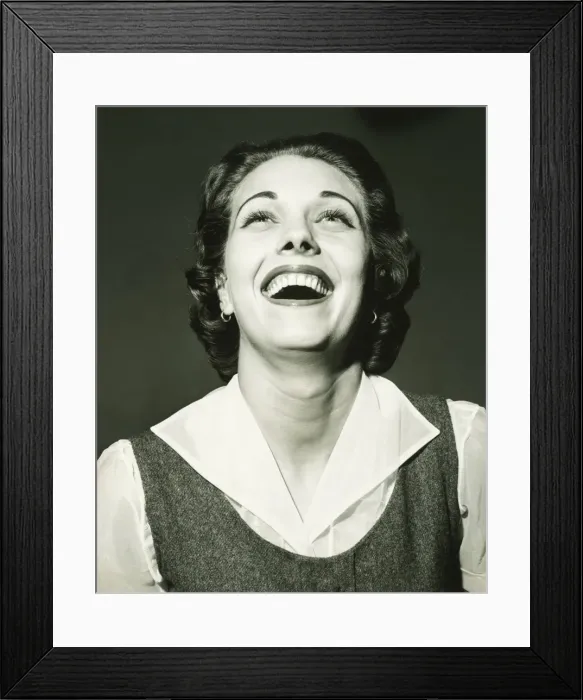 Framed Print : Laughing woman posing in studio, (B&W), portrait Framed Print : Laughing woman posing in studio, (B&W), portrait