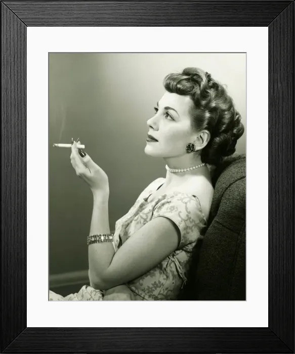 Framed Print : Elegant woman smoking cigarette, posing in studio, (B&W), portrait Framed Print : Elegant woman smoking cigarette, posing in studio, (B&W), portrait