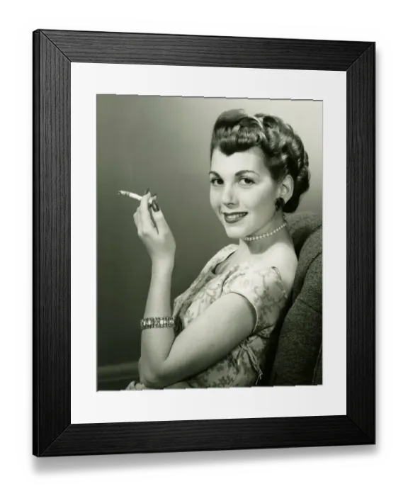 Framed Print : Elegant woman smoking cigarette, posing in studio, (B&W), portrait Framed Print : Elegant woman smoking cigarette, posing in studio, (B&W), portrait