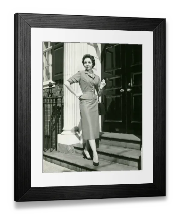 Framed Print : Elegant woman posing at entrance to building, (B&W), portrait Framed Print : Elegant woman posing at entrance to building, (B&W), portrait