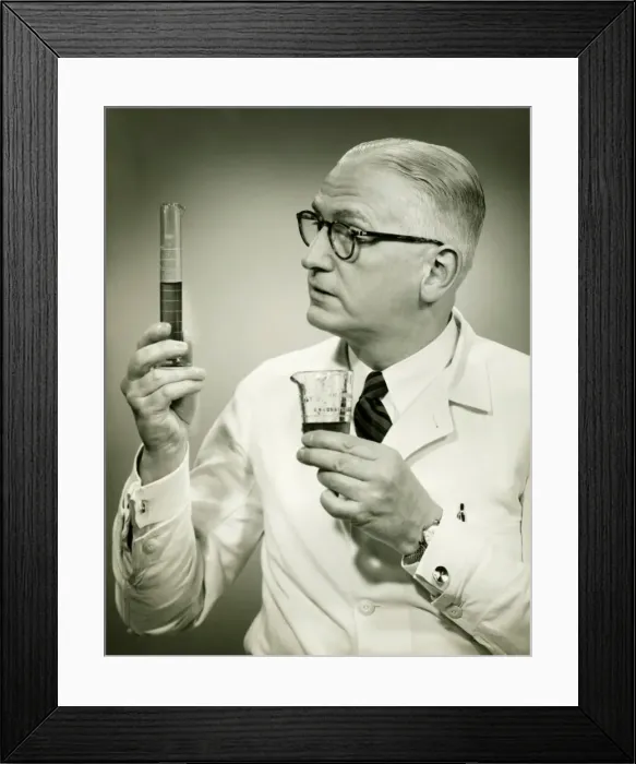 Framed Print : Doctor holding buretts in studio, (B&W), portrait Framed Print : Doctor holding buretts in studio, (B&W), portrait