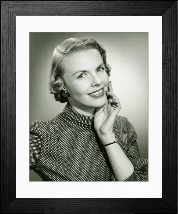 Framed Print : Smiling woman posing in studio, (B&W), portrait Framed Print : Smiling woman posing in studio, (B&W), portrait
