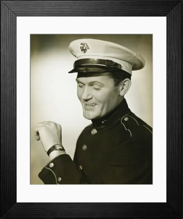 Framed Print : Marine in military uniform looking at wristwatch in studio, (B&W) Framed Print : Marine in military uniform looking at wristwatch in studio, (B&W)