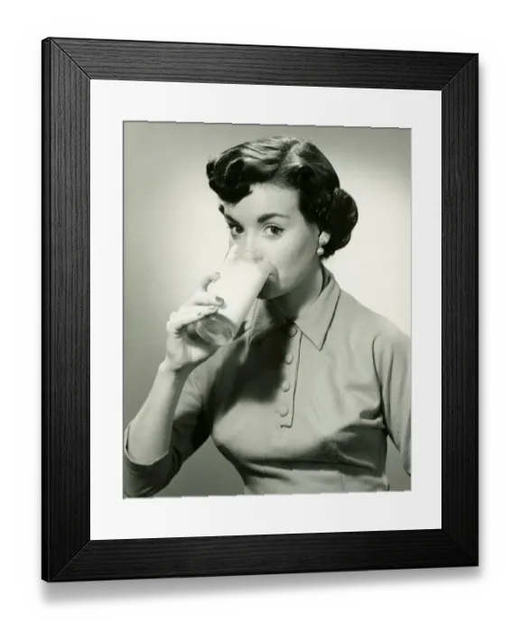 Framed Print : Young woman drinking glass of milk, (B&W), portrait Framed Print : Young woman drinking glass of milk, (B&W), portrait