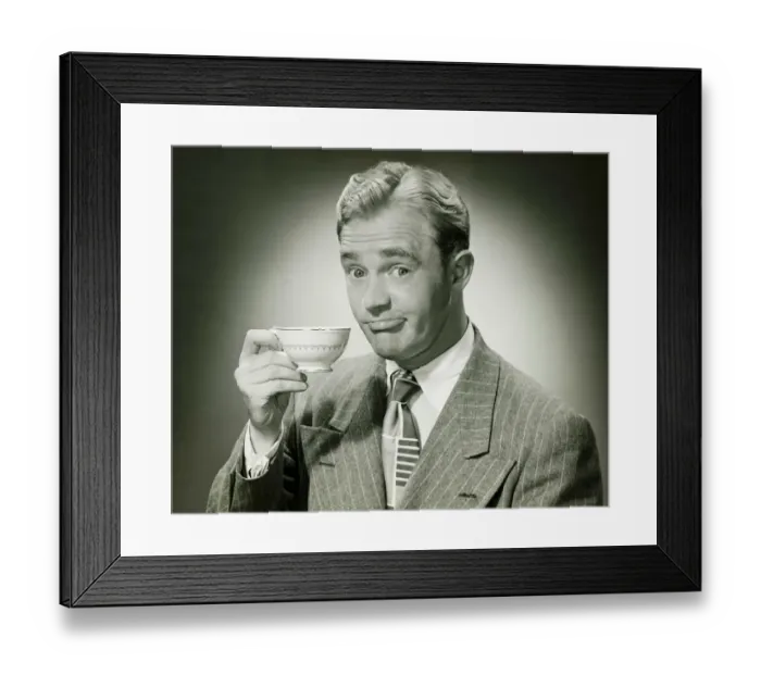 Framed Print : Businessman holding ceramic cup, (B&W), portrait Framed Print : Businessman holding ceramic cup, (B&W), portrait
