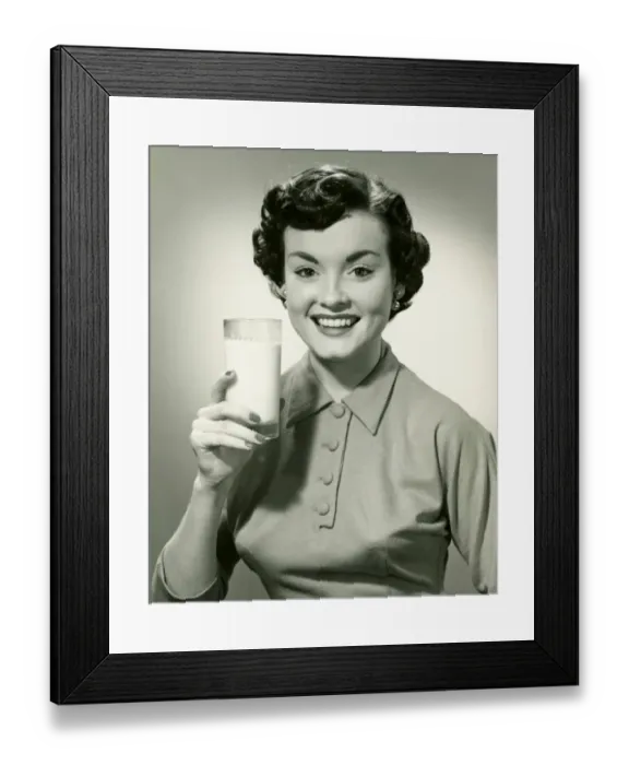 Framed Print : Young woman holding glass of milk, (B&W), portrait Framed Print : Young woman holding glass of milk, (B&W), portrait