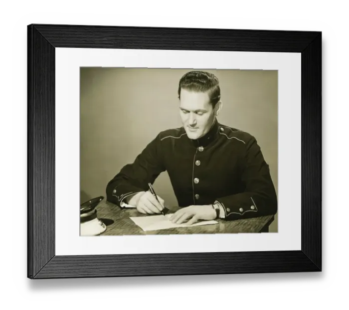 Framed Print : Marine in military uniform writing letter at desk, (B&W) Framed Print : Marine in military uniform writing letter at desk, (B&W)