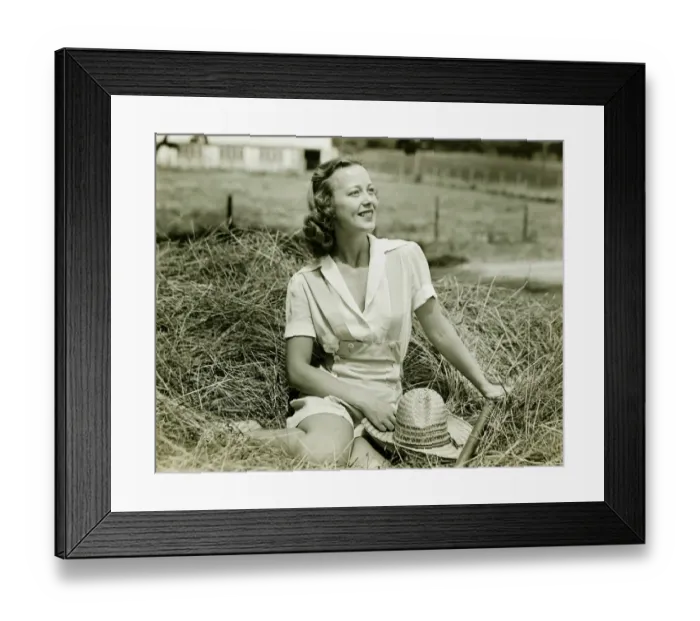 Framed Print : Woman sitting on haystack, (B&W), portrait Framed Print : Woman sitting on haystack, (B&W), portrait