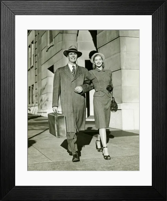 Framed Print : Young couple walking arm in arm on sidewalk, (B&W)