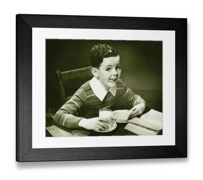 Framed Print : Boy (6-7) eating breakfast, (B&W), portrait Framed Print : Boy (6-7) eating breakfast, (B&W), portrait