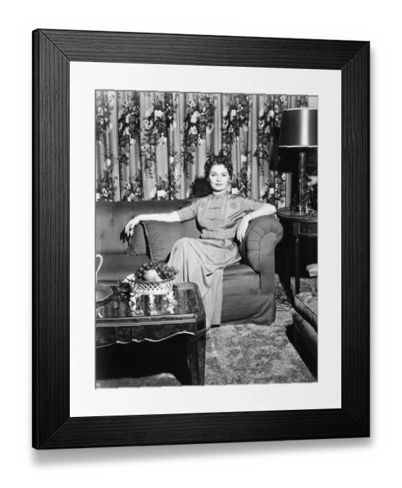 Framed Print : Woman sitting in rich living room, (B&W) Framed Print : Woman sitting in rich living room, (B&W)