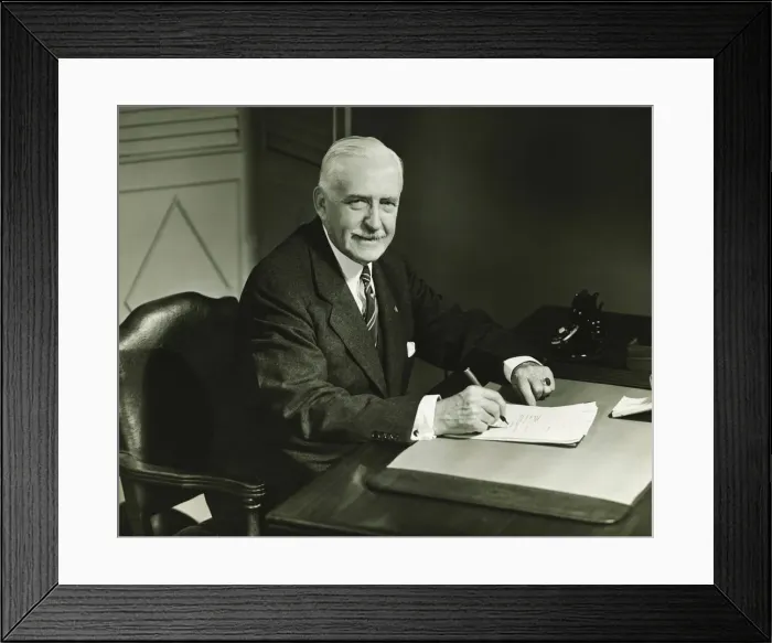 Framed Print : Senior businessman signing documents at desk, (B&W), portrait Framed Print : Senior businessman signing documents at desk, (B&W), portrait